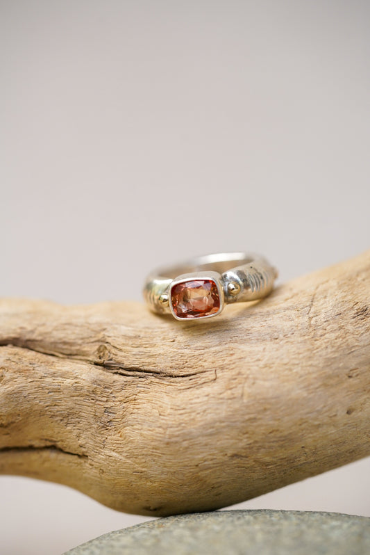 Sunstone silver ring on a piece of driftwood