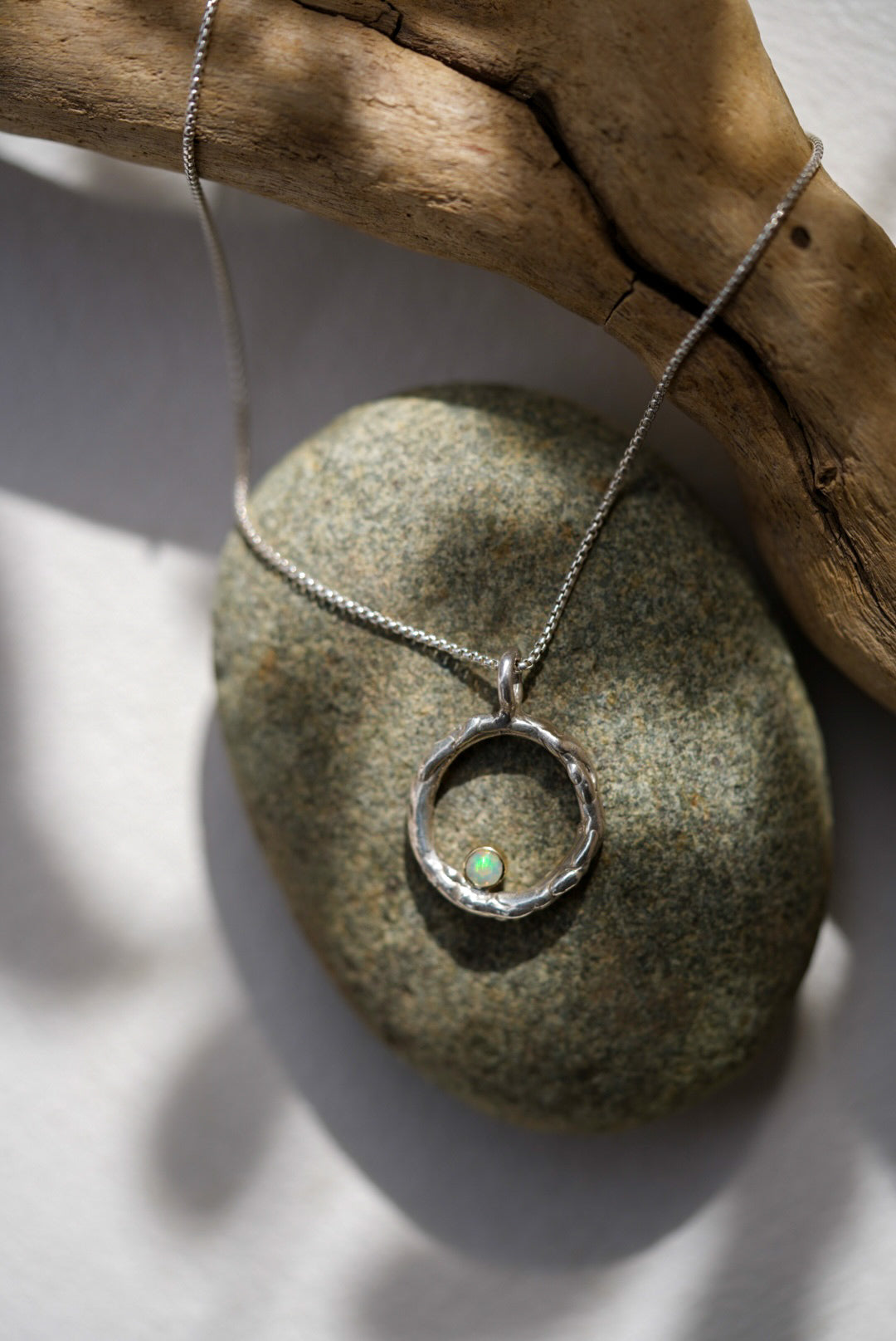 Silver necklace with a pendant on a stone