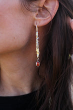 Load image into Gallery viewer, Close-up of a person wearing a silver earring and a red gemstone.