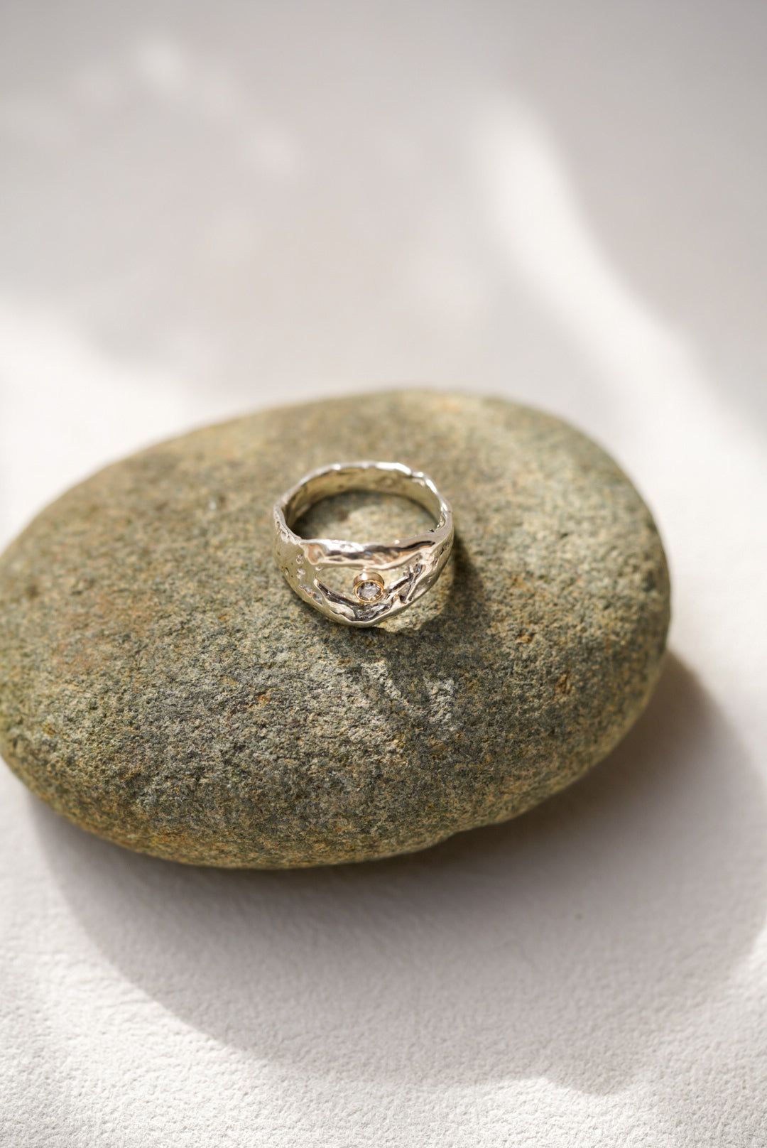 Silver ring on a textured stone surface