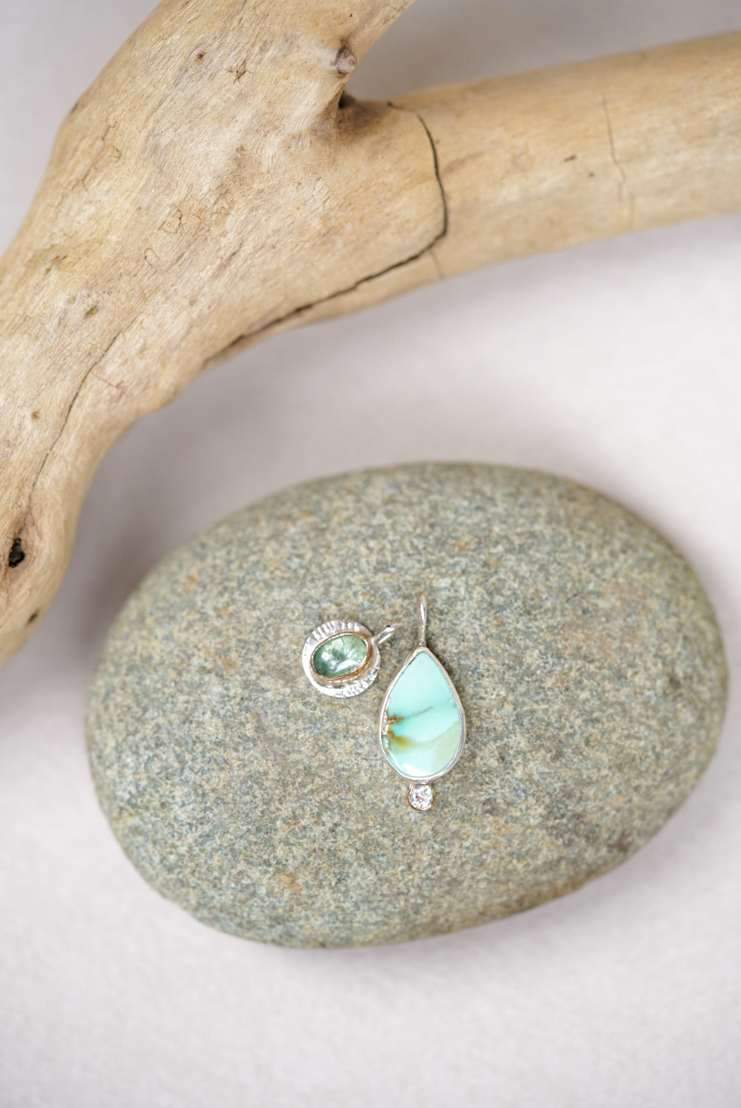 Pendants with a variscite stone and green kyanite on a stone surface