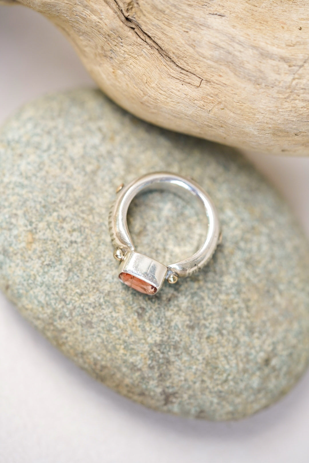 Sunstone silver ring next on a piece of river rock