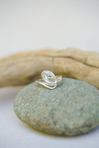 Silver ring on a stone with natural background
