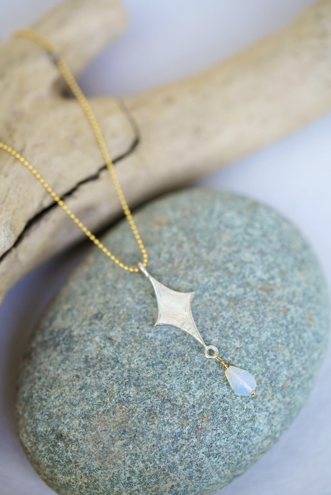 Necklace with a pendant on a stone surface
