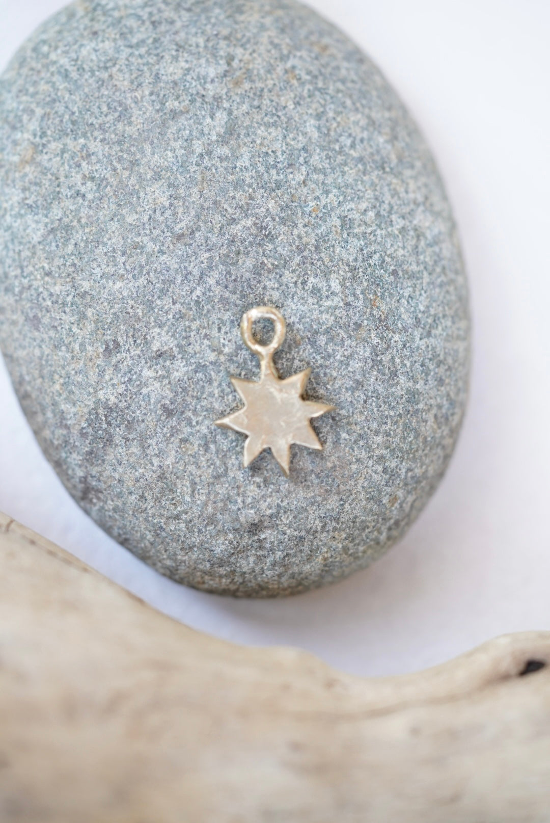 star charm in bronze on a rock