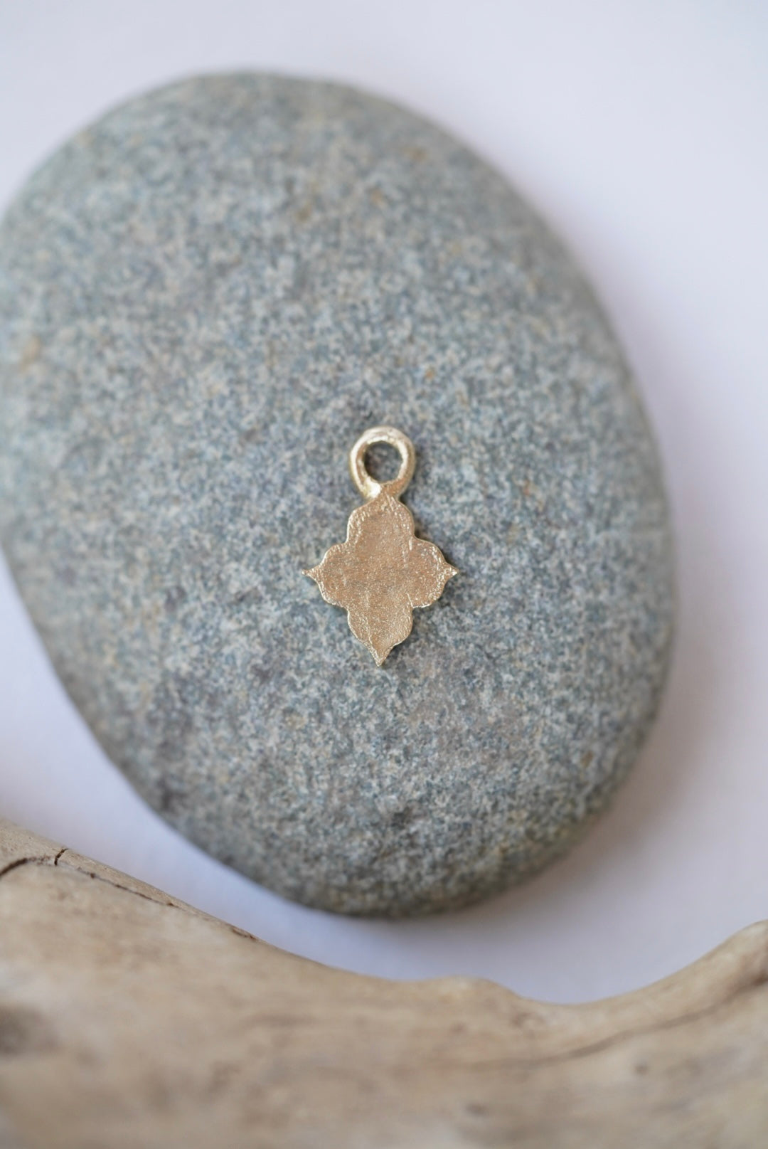 temple charm in bronze on a rock
