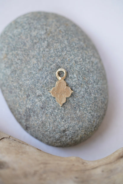 temple charm in bronze on a rock