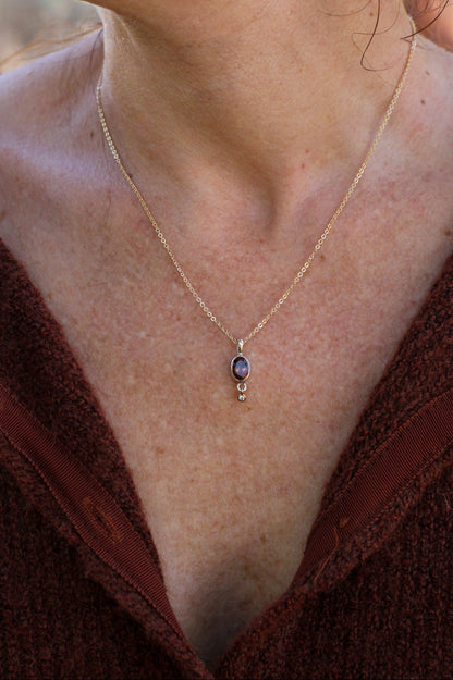 Necklace with a pendant worn by a person, close-up view.